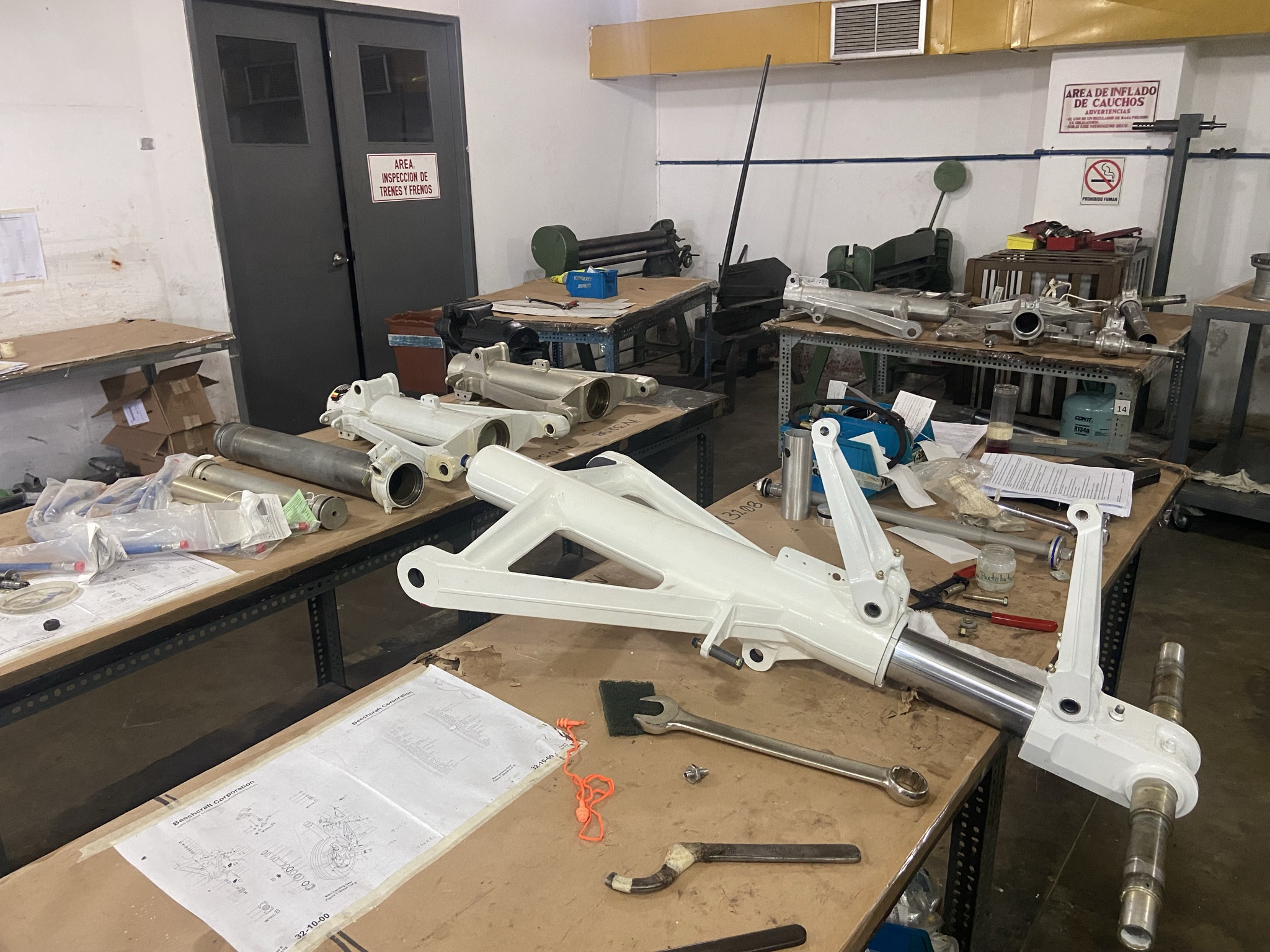 Disassembled landing gear components: inspection passed and ready for reassembly.